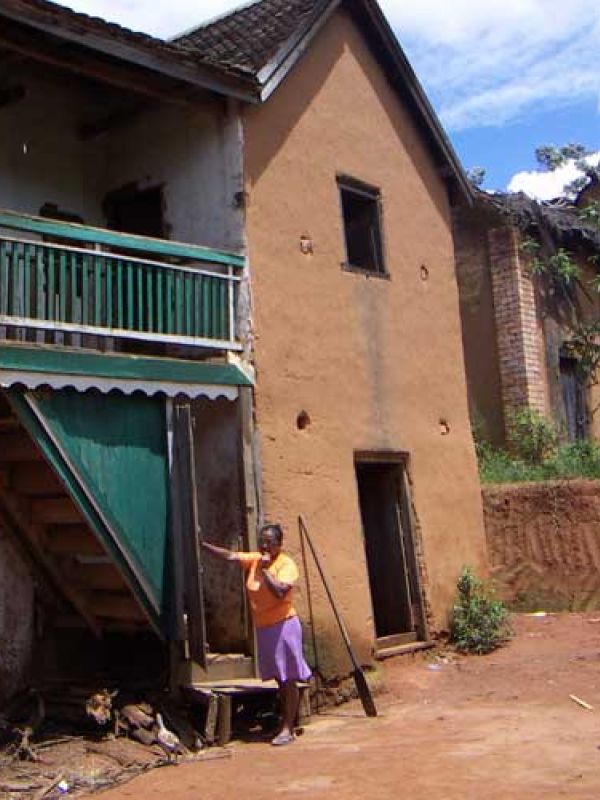 5. Mme Laure is sitting upstairs in her house weaving. Her house is typical for the region, built with local materials. 