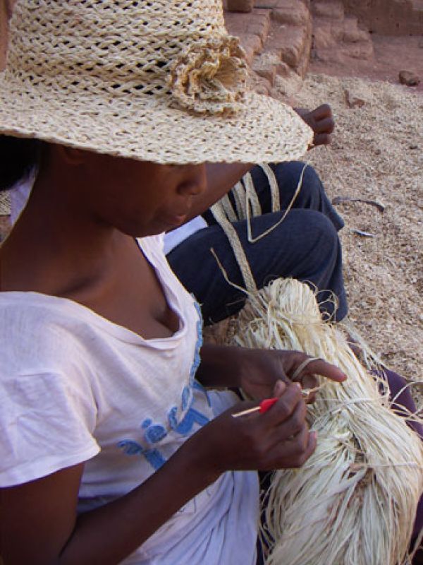 9 Madame Olga, in another village, starting crochet a flower. The flower is for type of that she herself  wears. Apart from the crochet flower, the hat is made with the craft techniques described above; first braiding band, then sewing the band together.