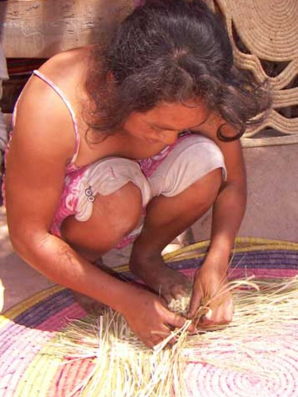 9. “Rariboka” is a basketry technique where the Haravola grass is combined with sundried raffia palm leaves. Here one of the women in the village who master this technique. 
