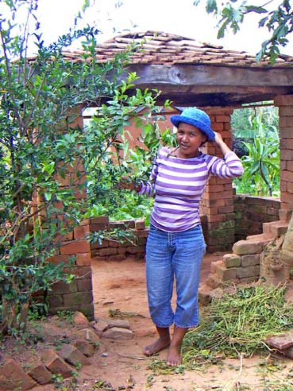 Step 7. Mme Eva in the hat she has just finished crochet using the sisal growing around her farm. 